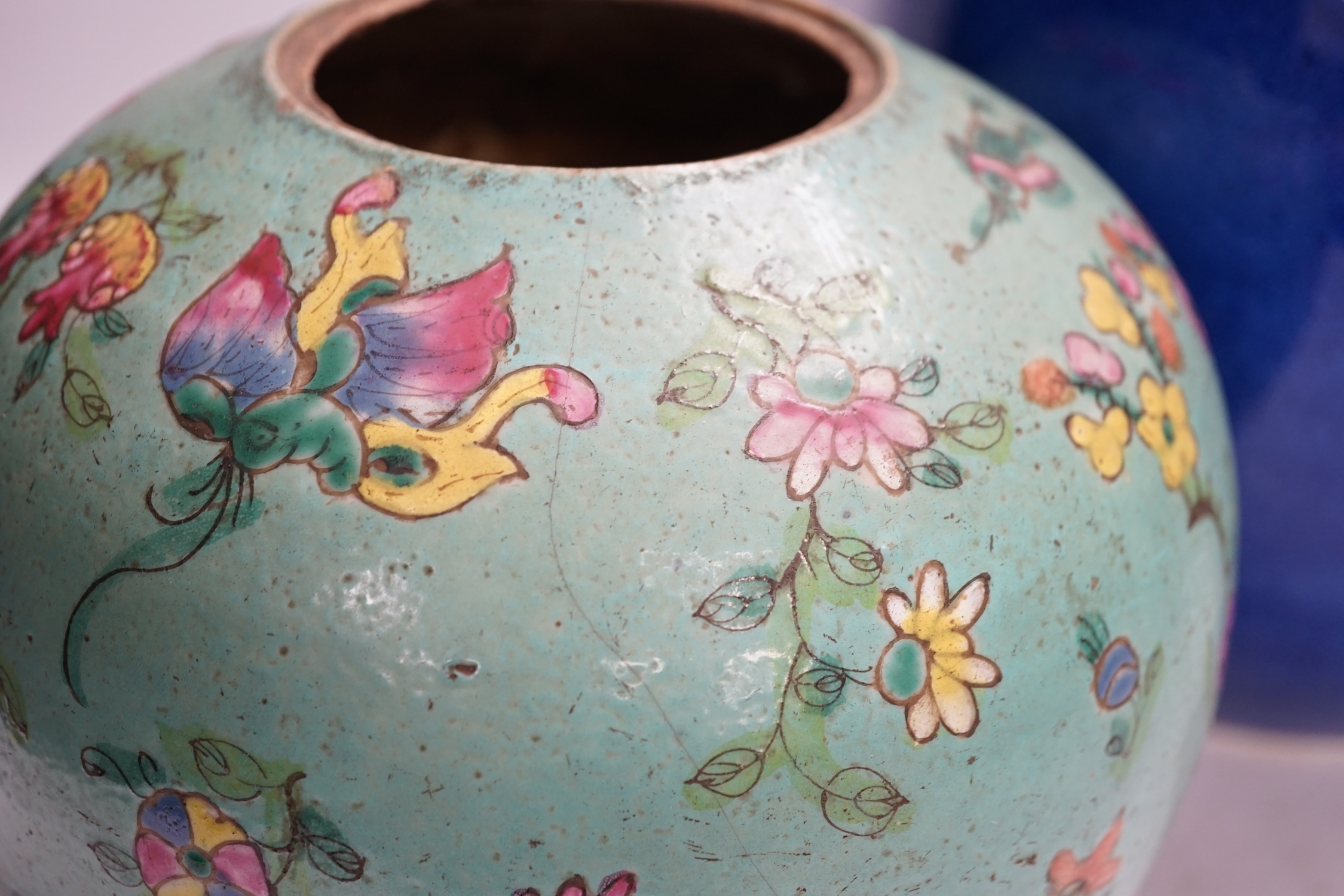 A Chinese powder blue jar, late 19th century, drilled hole to base and a turquoise glazed ground jar, blue vase 22cm high. Condition - turquoise jar cracked and chipped